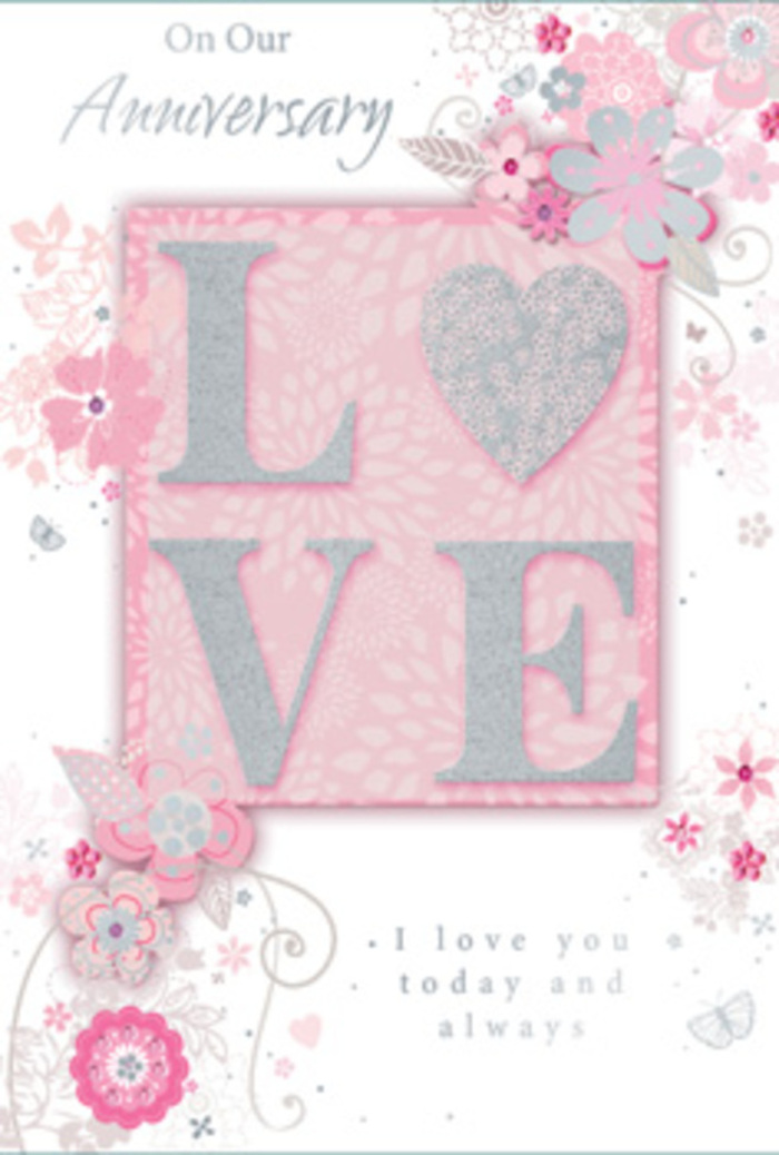 The photograph reveals an anniversary card that feels as serene and full of affection as a quiet morning walk through Weybridge's peaceful lanes. Dominating the centre is the word LOVE, printed in bold yet graceful letters and finished with an elegant, frosted glitter that adds a soft, crystalline sparkle. Under the fingertips, the raised letters would feel slightly rough, like the textured centre of a fresh bloom selected with care at a local florist. The colour of the letters shifts subtly between pearlescent white and pale pink, with hints of silver glinting where the light catches, giving the impression of sunlight brushing across petals. Surrounding this central motif, wispy, hand-drawn flowers and delicate sprays drift along the borders and corners of the card. The blooms are gently stylised, their petals in shades of blush pink, lilac-grey, and creamy ivory, blending harmoniously like a pastel bouquet ready for delivery across Weybridge and nearby streets. Dainty leaves, curling stems, and fine filigree lines weave between the flowers, suggesting graceful movement, as though a light breeze were stirring the arrangement. Here and there, tiny butterfly-like shapes and faint flourishes hide among the swirls, barely noticeable at first glance but adding to the sense of layered detail. The background is a soft, warm pink with a slightly velvety visual texture, helping the white and silver accents stand out without any harsh contrast. Nestled within the design, the message I love you today and always is printed in an understated, flowing script, offering a heartfelt promise without overwhelming the artwork. The entire card feels like a hand-tied bouquet translated into delicate illustration-a tender tribute to ongoing love and gratitude in Weybridge.